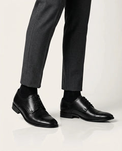 Regal Black worn with gray pants on a white background