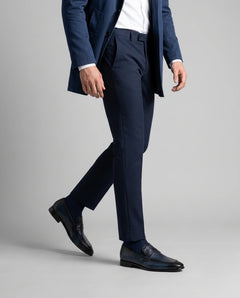 Alton blue leather loafers worn with tailored outfit in lifestyle walking shot showcasing modern elegance and luxury menswear style