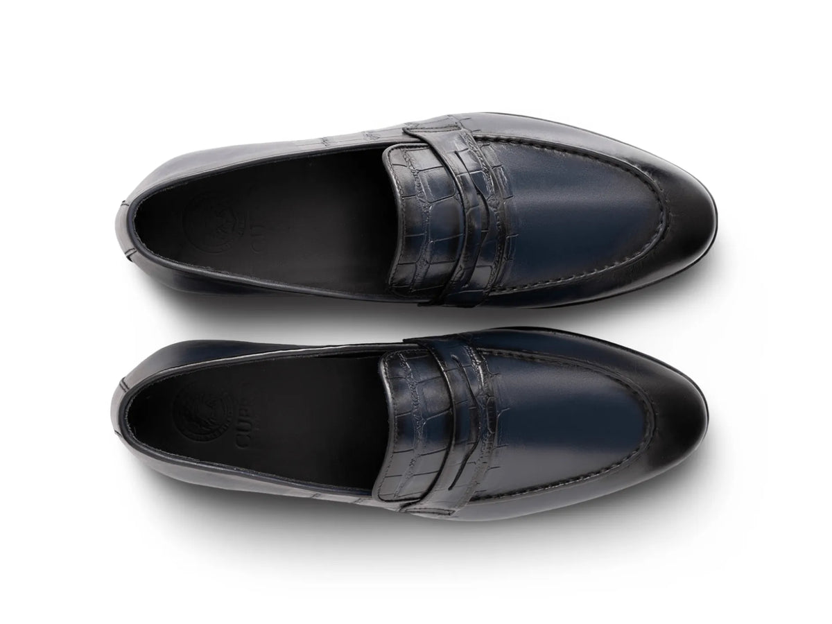 Top angled view of Alton blue leather loafers showing stitching detail, smooth leather finish, and refined craftsmanship