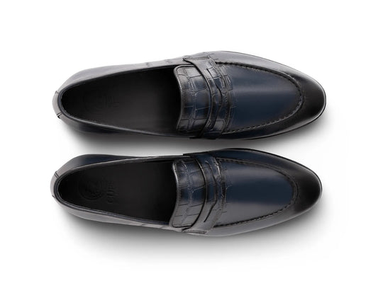 Top angled view of Alton blue leather loafers showing stitching detail, smooth leather finish, and refined craftsmanship