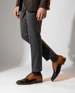 Askari two-tone leather brogues worn while walking in tailored outfit highlighting confident luxury formal menswear style
