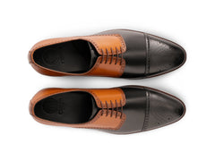 Top angled view of Askari two-tone leather brogues showing lace structure, brogue perforation, and handcrafted luxury finishing