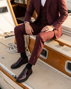 Beaumont burgundy patent leather oxford dress shoes styled with maroon suit in a luxury boat lifestyle setting