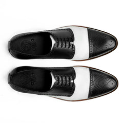 Top view of Bold Brogue shoes showing lace structure, brogue perforation, and black and white contrast leather design