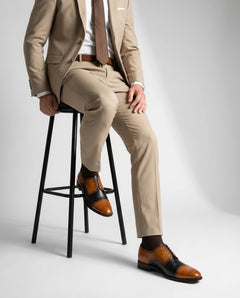 Chester Luxe lace-up shoes worn with tailored outfit in seated lifestyle pose showcasing elegance and luxury menswear style