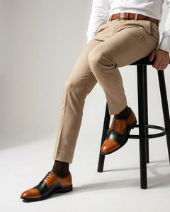 Chester Luxe lace-up shoes styled in seated pose highlighting comfort, craftsmanship, and refined formal footwear design