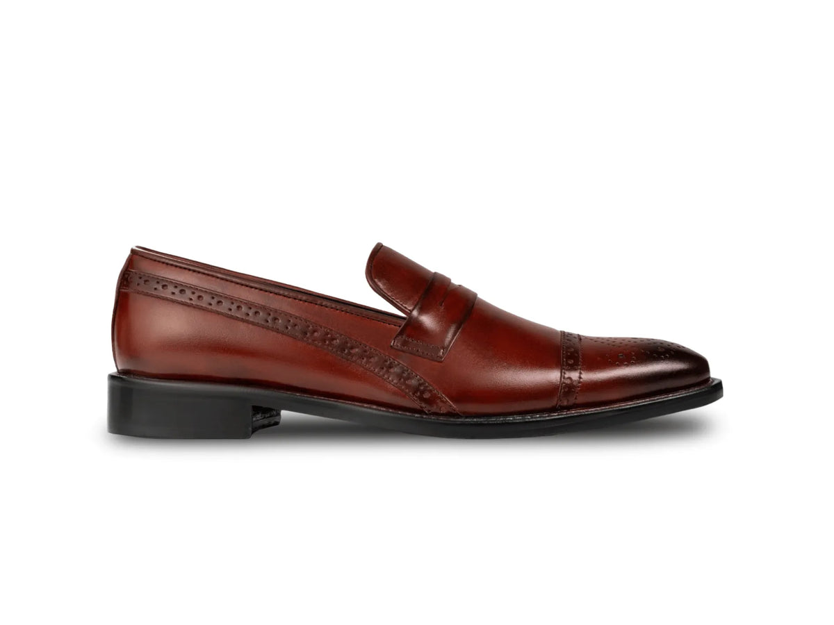 Side profile of cognac brown brogue loafers highlighting sleek silhouette, polished leather finish, and refined craftsmanship