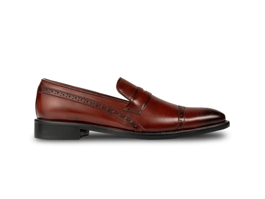 Side profile of cognac brown brogue loafers highlighting sleek silhouette, polished leather finish, and refined craftsmanship