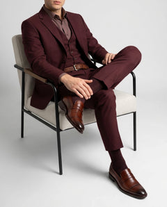 Cognac brown brogue loafers styled with formal outfit in seated lifestyle pose highlighting comfort, craftsmanship, and premium elegance
