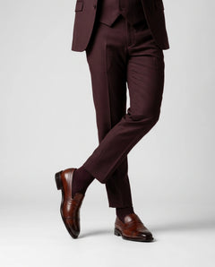 Cognac brown brogue loafers worn with tailored outfit in standing lifestyle shot showcasing elegance, confidence, and luxury menswear style
