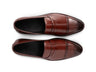 Top view of cognac brown brogue loafers showing perforated brogue detailing, stitching precision, and premium handcrafted leather texture