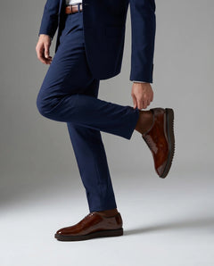 The Beaumont Cueřo Grand Atelier luxury men’s brown formal dress shoes worn in a studio walking pose showing elegance and premium formal style