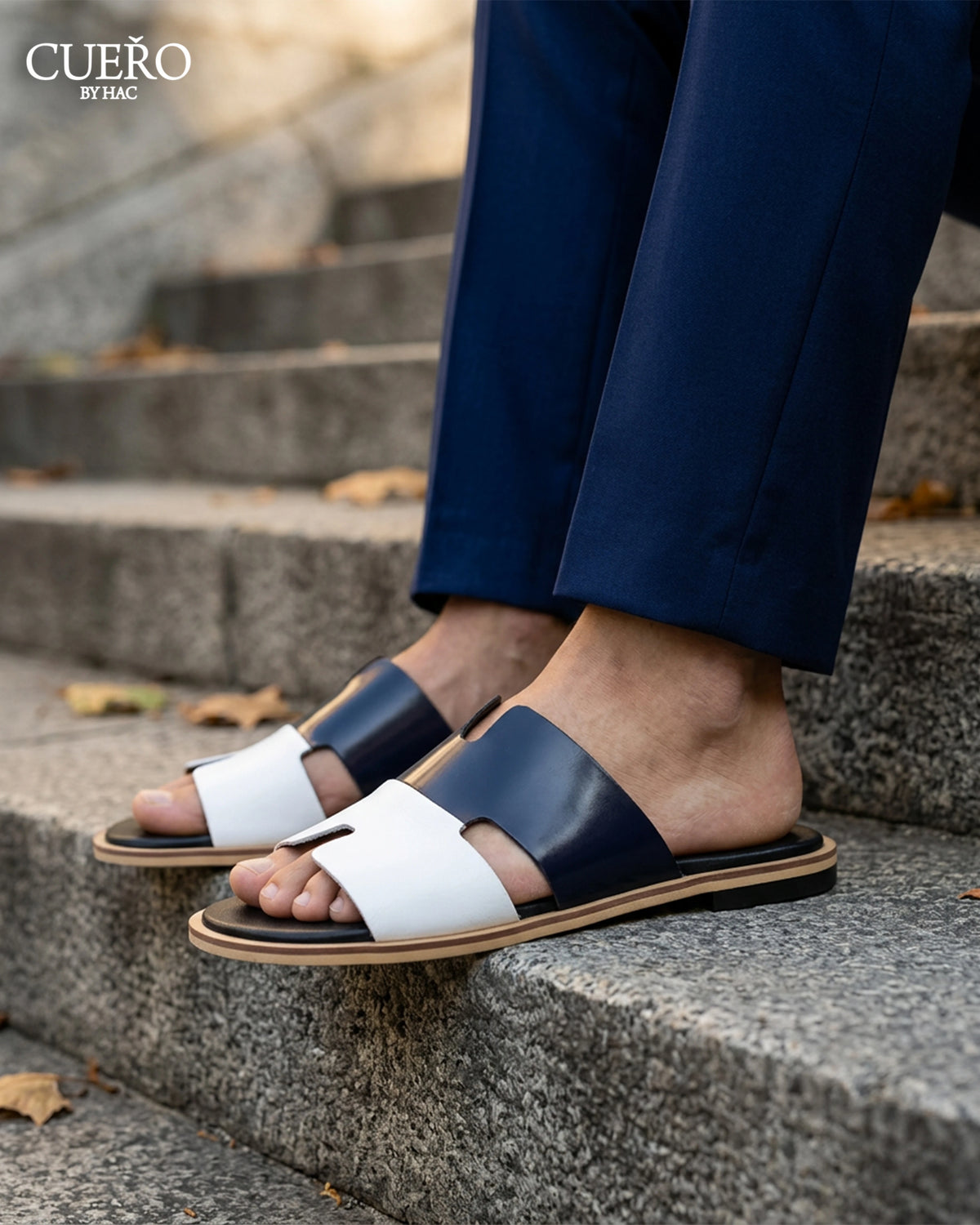 Close-up of Dastan Navy White luxury patent leather slides with refined detailing
