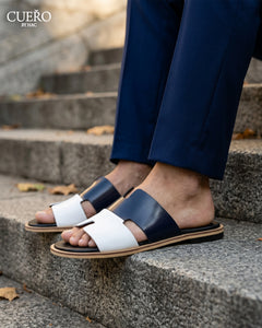 Close-up of Dastan Navy White luxury patent leather slides with refined detailing