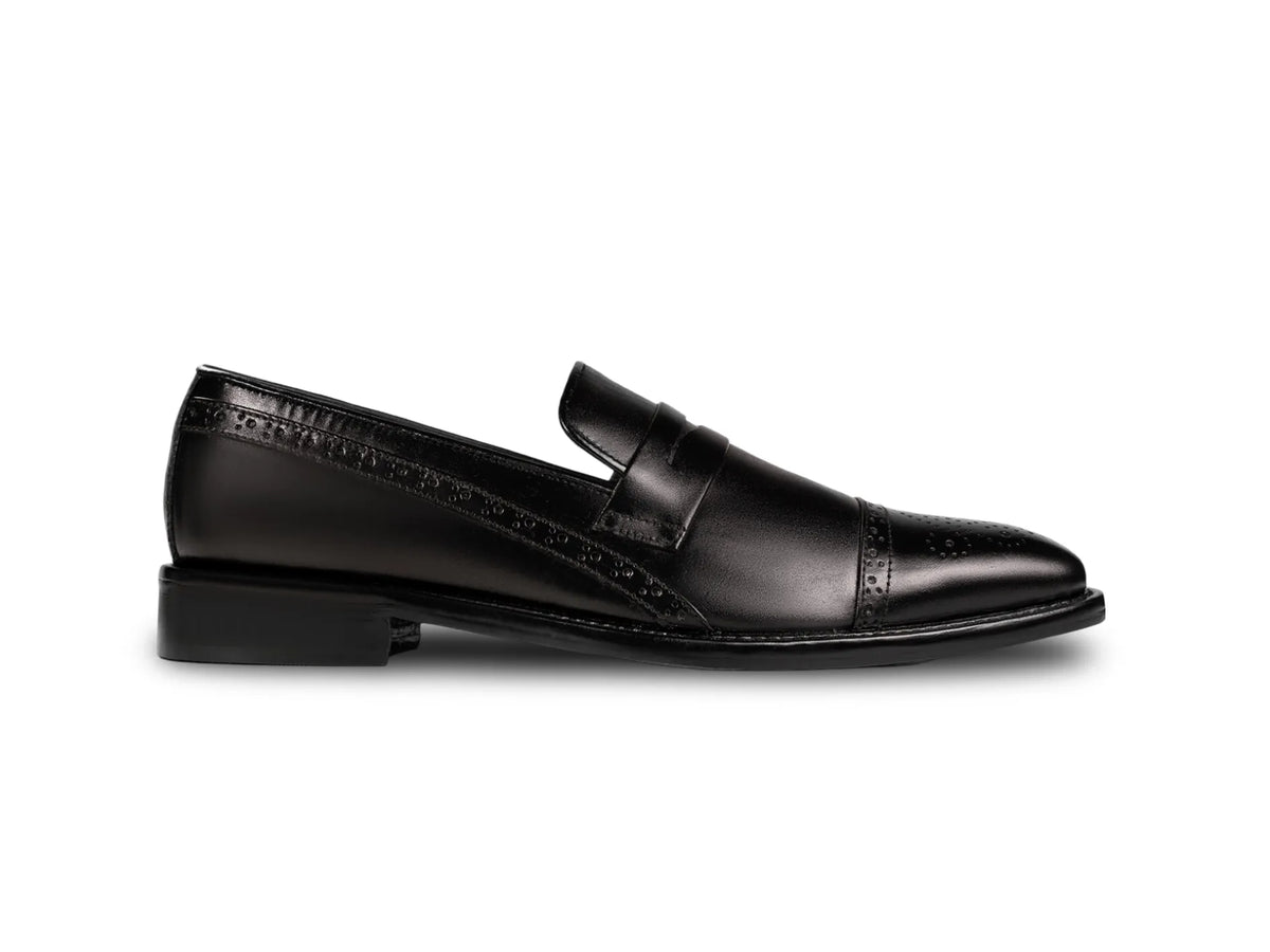 Side profile of Deyoshi black leather loafers highlighting sleek silhouette, refined stitching, and handcrafted luxury finish