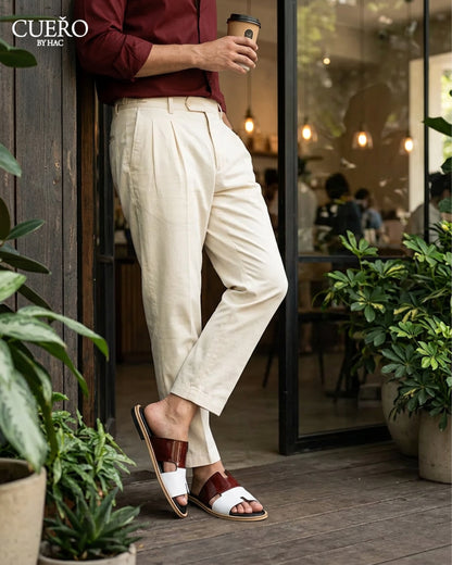 Modern patent leather slides photographed in luxury editorial environment