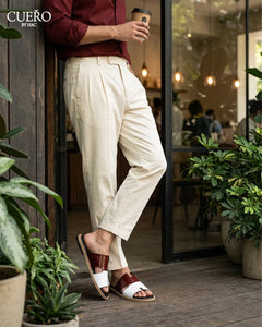 Modern patent leather slides photographed in luxury editorial environment