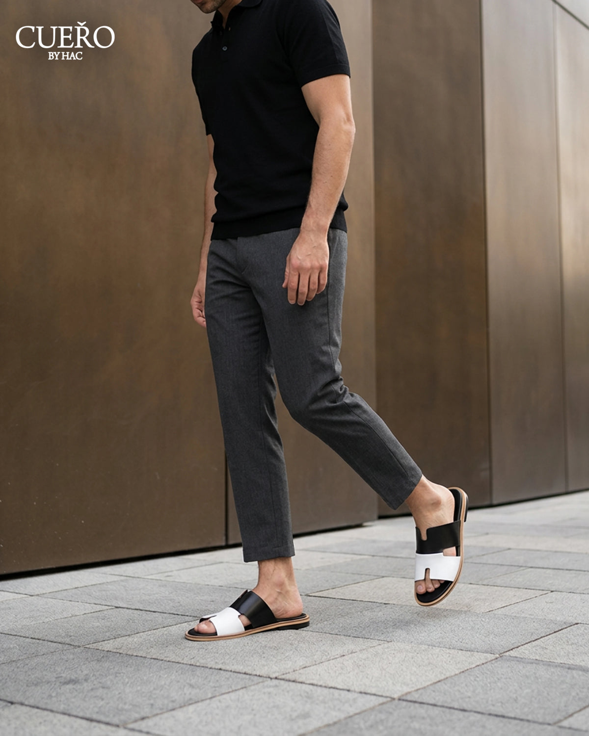 Man walking in Dujan Black White minimalist leather slides for men