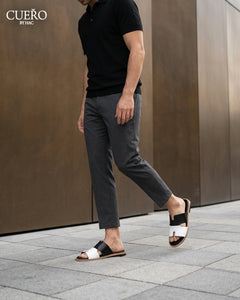 Man walking in Dujan Black White minimalist leather slides for men