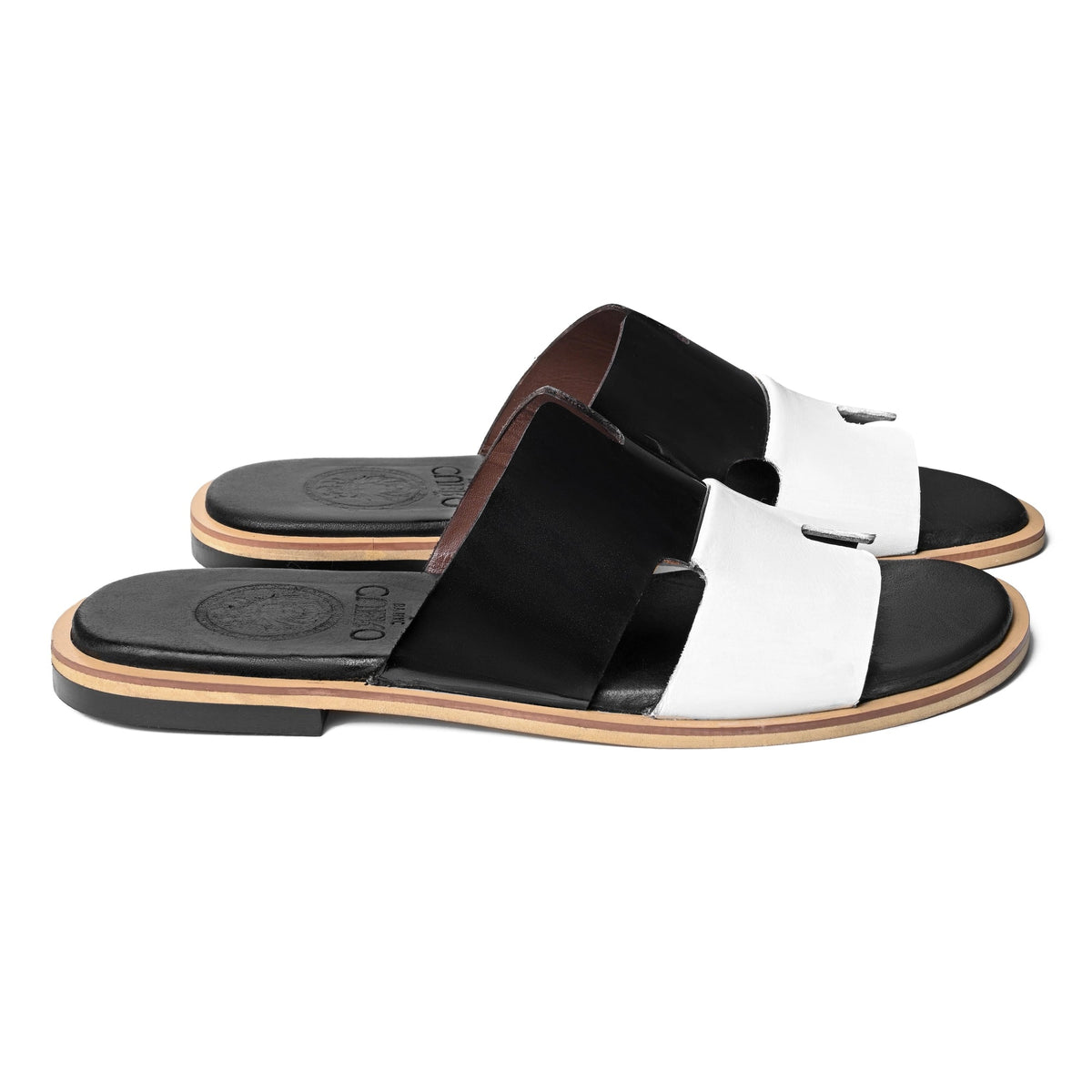 Front pair view of Dujan premium black and white leather slippers for men by Cuero by HAC