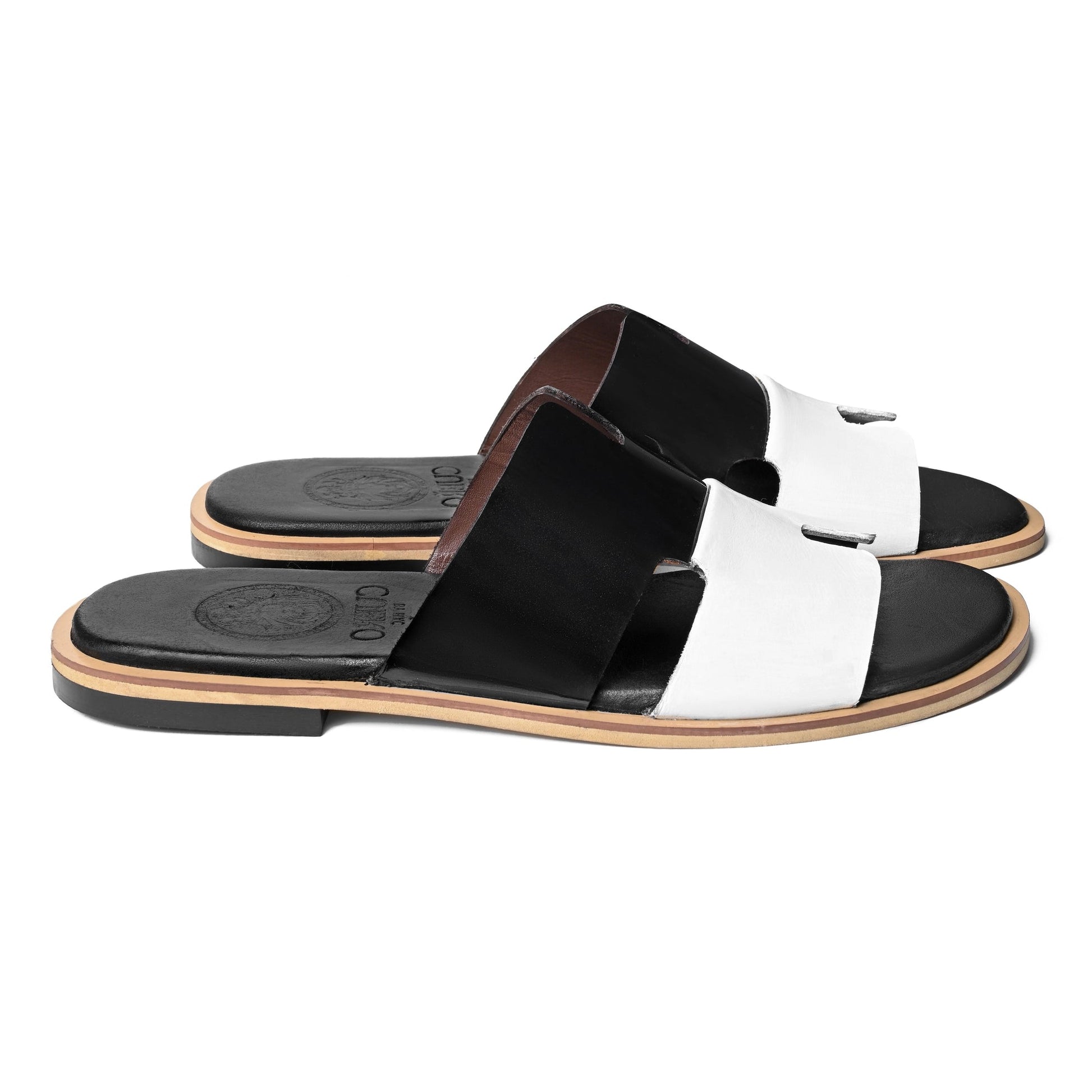 Front pair view of Dujan premium black and white leather slippers for men by Cuero by HAC