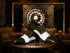 Artistic close-up of Ebony and Ivory brogue shoes highlighting green suede, white contrast, and premium craftsmanship detail