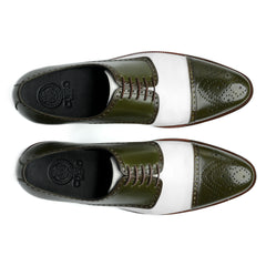 Top view of Ebony and Ivory brogue shoes showing lace structure, perforated detailing, and bold green and white contrast design