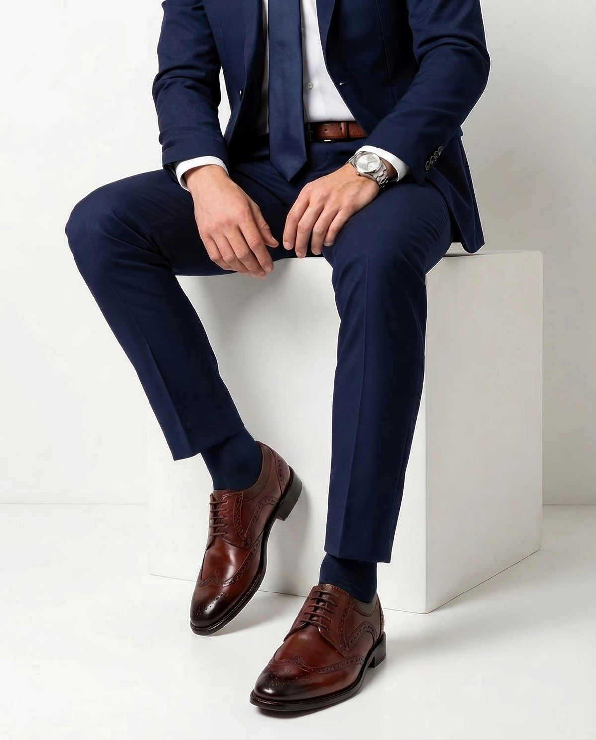 Edwin Brown lace-up shoes styled with formal outfit in seated lifestyle pose showcasing elegance and modern menswear sophistication