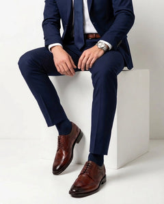 Edwin Brown lace-up shoes styled with formal outfit in seated lifestyle pose showcasing elegance and modern menswear sophistication