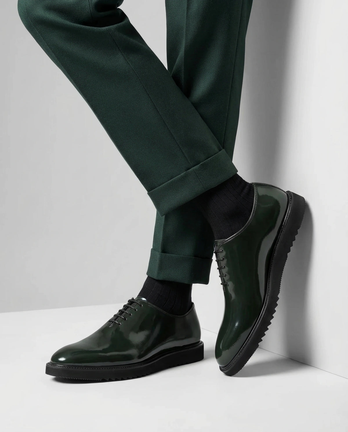 Close-up of Elroy green glossy lace-up shoes showing premium patent leather finish, fine stitching, and high shine surface with luxury craftsmanship detail