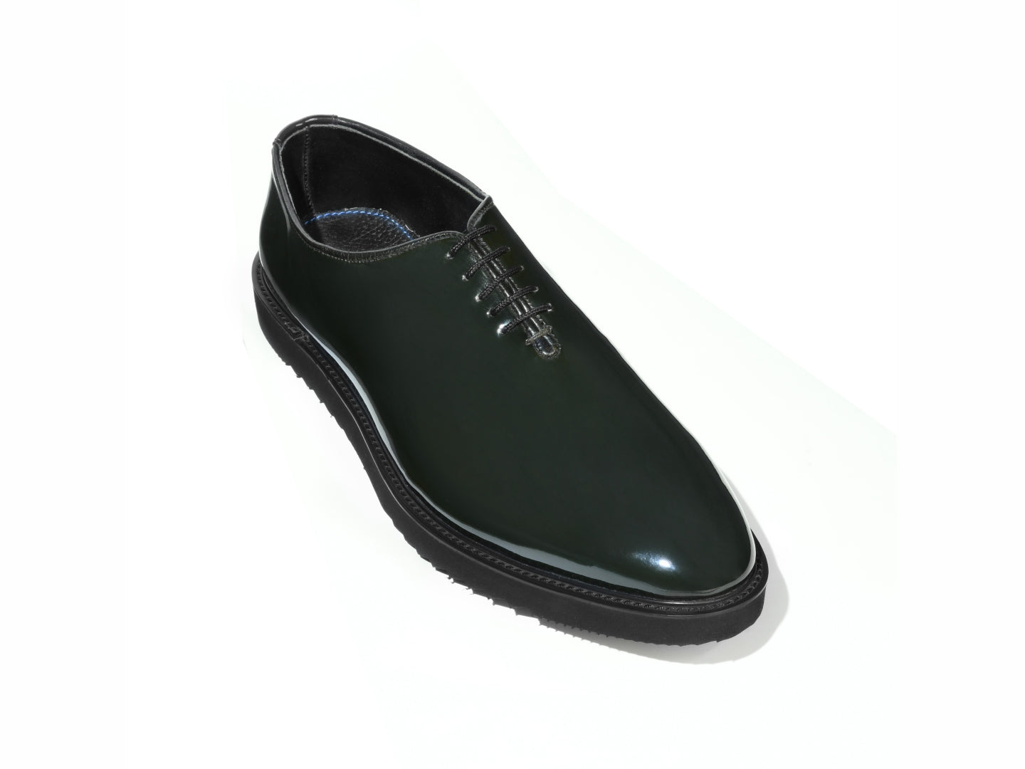 Elroy luxury green patent leather lace-up shoes with high shine finish and commando rubber sole displayed in clean minimal studio setup