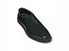 Elroy luxury green patent leather lace-up shoes with high shine finish and commando rubber sole displayed in clean minimal studio setup