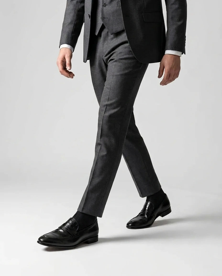 Hudson black leather loafers worn while walking in tailored outfit showcasing modern luxury menswear and confident formal style