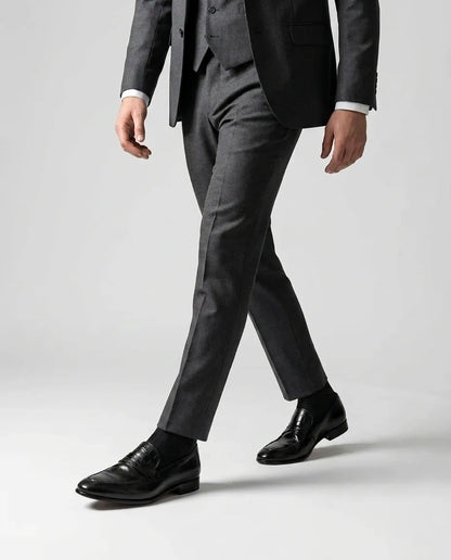 Hudson black leather loafers worn while walking in tailored outfit showcasing modern luxury menswear and confident formal style