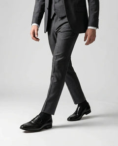 Hudson black leather loafers worn while walking in tailored outfit showcasing modern luxury menswear and confident formal style
