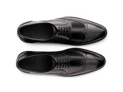 Top angled view of Huxley black lace-up shoes showing lace structure, stitching detail, and premium formal leather craftsmanship