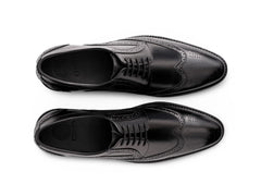 Top angled view of Huxley black lace-up shoes showing lace structure, stitching detail, and premium formal leather craftsmanship