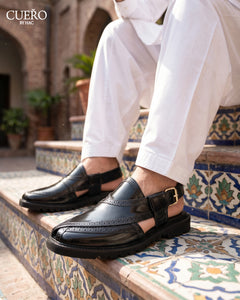 Man wearing black woven Peshawari chappal with traditional shalwar kameez