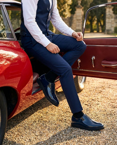 Lucifer navy blue patent leather oxford dress shoes paired with tailored suit in a luxury vintage car setting