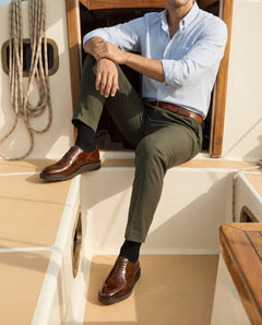 Marcellus brown derby shoes styled with tailored outfit on yacht setting representing luxury men’s fashion lifestyle