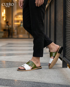 Modern patent leather slides photographed in luxury editorial environment
