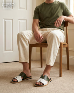 Luxury olive leather slippers captured in motion in contemporary setting