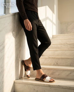 Designer burgundy leather slides photographed in modern editorial setting