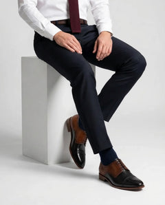 Two-Toned Alfred lace-up shoes worn in seated lifestyle pose highlighting comfort, craftsmanship, and refined gentleman aesthetic