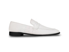 Side profile of Wilfred white leather loafers highlighting sleek silhouette, smooth leather finish, and refined luxury craftsmanship